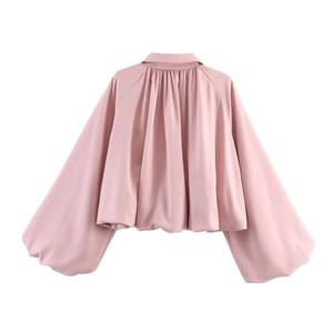 Detail view of pink jacket back featuring pleated textures and puff balloon sleeves