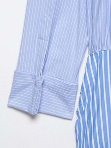 Detailed macro view of striped shirt cuff featuring neat stitching and single button closure