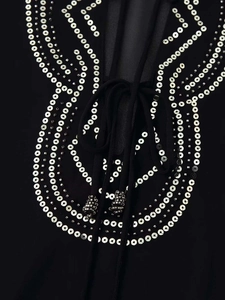 Detail view of black shirt neckline with silver sequins, beads and ethnic patterns