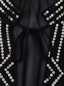 Detail of black sheer chiffon shirt with silver sequins and lace-up back design