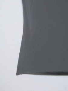 Detailed close-up of dark grey seamless tank top hem showing fine stitching and fabric texture