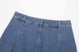 Macro shot of light blue denim waistband with belt loops and double stitching details
