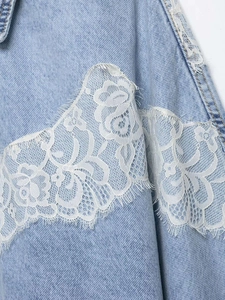 Close-up of white floral lace trim on light blue denim jacket with eyelash edge detail
