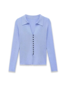 Detail of ribbed texture and black buttons on light blue polo collar cardigan sweater