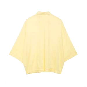 Rear view of a light yellow short-sleeved cotton shirt with a loose minimalist fit