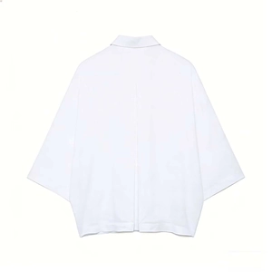 Detail of white cotton shirt back showing box pleat and loose oversized silhouette