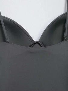 Detail of dark grey seamless camisole featuring thin straps and built-in molded cups