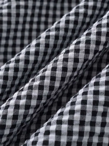 Detailed macro view of black and white gingham fabric texture showing fiber weave