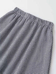 Detail shot of black and white gingham skirt with comfortable elastic waistband and pleats