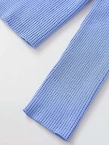 Close-up of light blue ribbed knit fabric showing detailed texture and soft elasticity