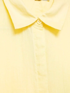 Detail of light yellow shirt featuring breathable cotton-linen fabric and clean stitching
