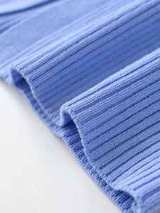 Macro shot of light blue ribbed knit fabric showing the detailed texture and soft material