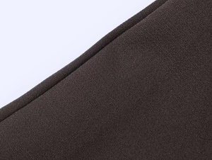 Macro shot of dark brown fabric texture with fine granular weave for formal blazers