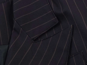 Detail of pinstripe pattern and neat stitching on navy blue blazer lapel fabric