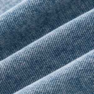 Macro shot of the durable blue denim fabric texture and diagonal twill weaving pattern