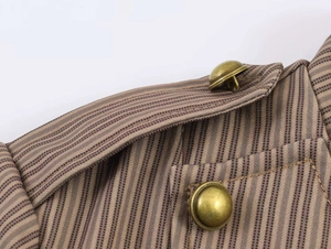 Macro shot of striped blazer shoulder with vintage gold buttons and military epaulettes