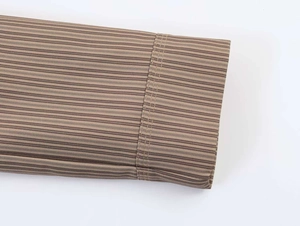 Close-up of brown striped blazer cuff showing fine fabric texture and premium stitching detail
