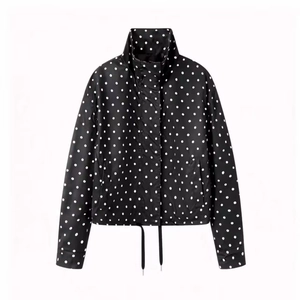 Detailed view of black polka dot jacket with stand collar and adjustable drawstring hem