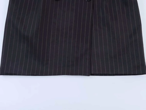 Detailed close-up of dark striped dress fabric showing vertical pinstripe texture
