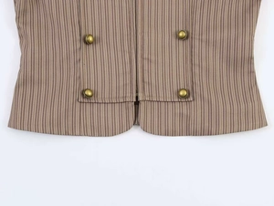 Detailed macro view of pinstriped vest with vintage copper buttons and fabric texture