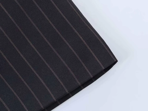 Detailed close-up of dark pinstripe dress fabric showing high-quality woven texture