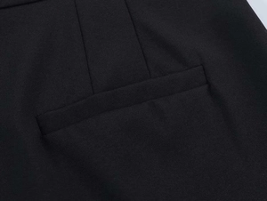 Detail of rear welt pocket and precise darts on black twill suit trousers