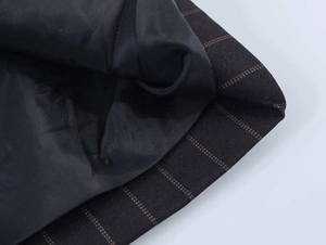 Detailed close-up showing fine vertical stripes and smooth black inner lining of the blazer