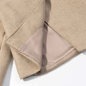 Detail of camel wool coat showing neat stitching and smooth inner polyester lining