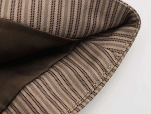 Close-up of pinstripe blazer fabric and smooth brown inner lining stitching detail