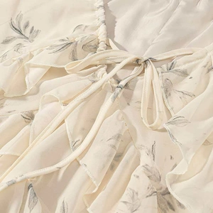 Chiffon midi dress featuring ruffle details and elegant leaf prints with a bow neckline