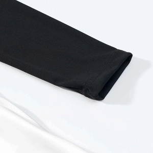 Detailed close-up of black ribbed fabric cuffs with premium double-stitch finishing details