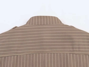 Detailed close-up of brown striped blazer collar showing premium fabric texture and sewing