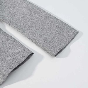 Detailed macro view of the grey blazer sleeve showing high-quality woven fabric texture