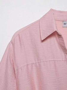 Detailed macro view of the pink linen shirt collar with professional stitching quality
