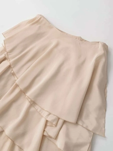 Detailed view of layered ruffles and soft texture on this beige chiffon maxi skirt