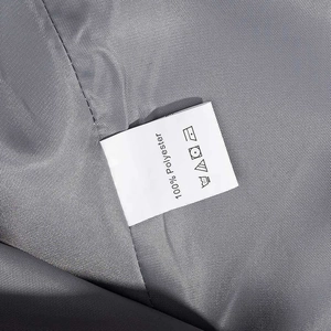Detail shot of the care label showing 100% polyester fabric and washing instructions