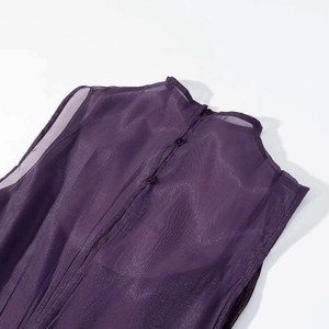 Detail of elegant purple mesh gown showing delicate back button closure and sheer fabric
