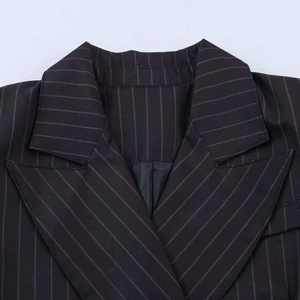 Classic black pinstripe blazer featuring a sharp notched lapel and premium fabric texture