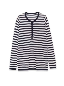 Detail of the Henley collar and five buttons on this black and white striped knit top