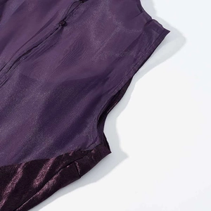 Detail of dark purple mesh patchwork on velvet dress with delicate button closure