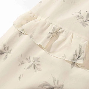Elegant floral print tiered midi dress with ruffled details and beige leaf pattern