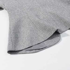 Detailed macro shot of grey textured fabric blazer hem with neat stitching and smooth lining