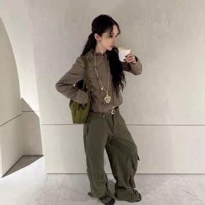 Women's autumn striped slim jacket and green cargo trousers with gold heart necklace