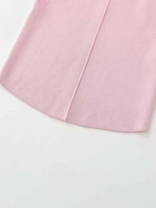 Detailed close-up of pink knit fabric with curved hemline and vertical stitching