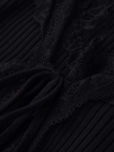Detailed close-up of ribbed knit fabric featuring delicate black floral lace and a tie-up design