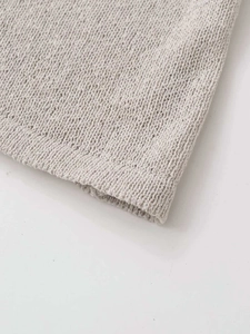 Close-up of light grey knitted tank top showing premium fabric texture and hem detail
