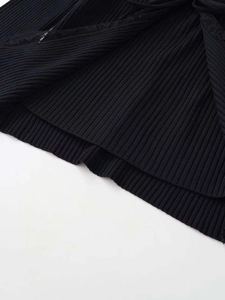 Detail view of black ribbed knit sweater featuring delicate lace trim on the edges