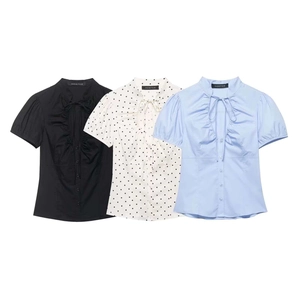 Women's short sleeve V-neck ruffle shirts in solid black, polka dots, and light blue