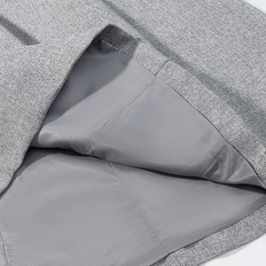 Close-up of gray woven blazer fabric and smooth matching inner lining with neat seams