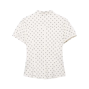 Detail of white short-sleeved shirt featuring classic black polka dots and back tailoring